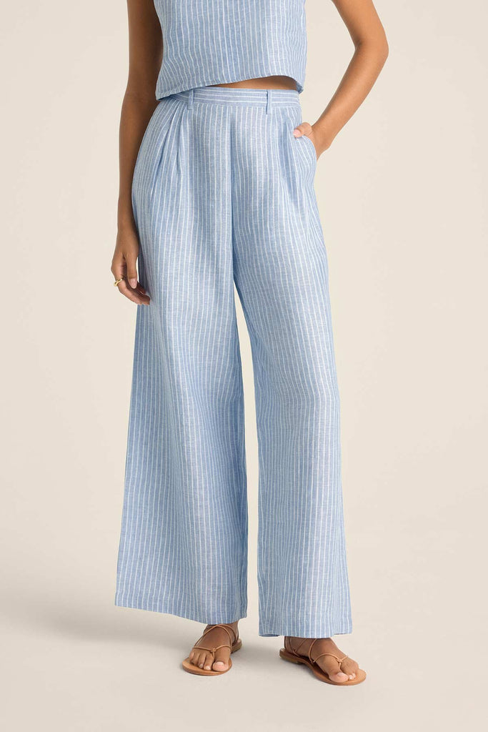 Woman wearing a blue and white striped beach tank top with matching beach pants. Close up of the detail