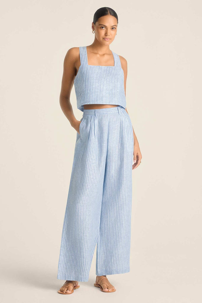 Woman wearing a blue and white striped beach tank top with matching pants