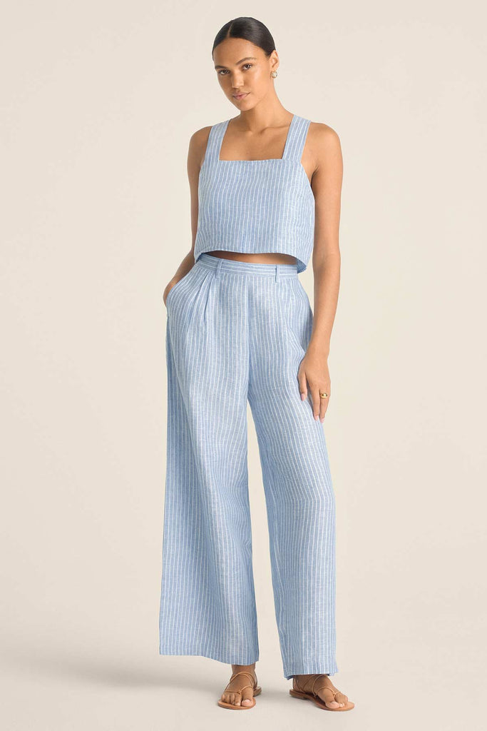Woman wearing a blue and white striped beach tank top with matching beach pants