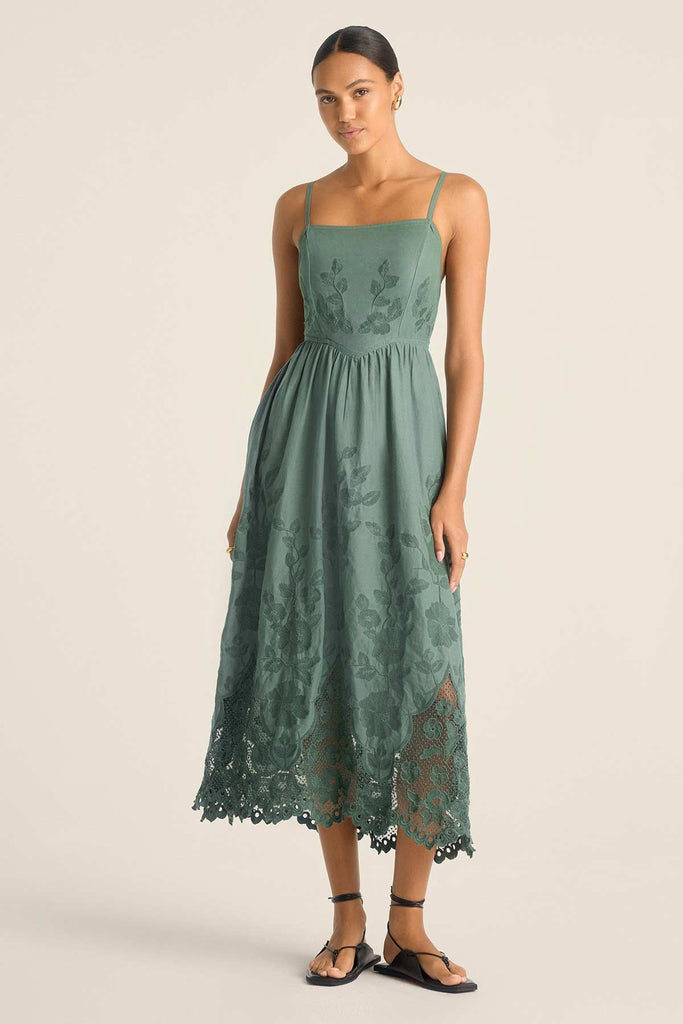 Woman wearing a sea green lacy beach dress