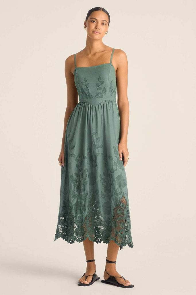 Woman wearing a sea green lacy beach dress