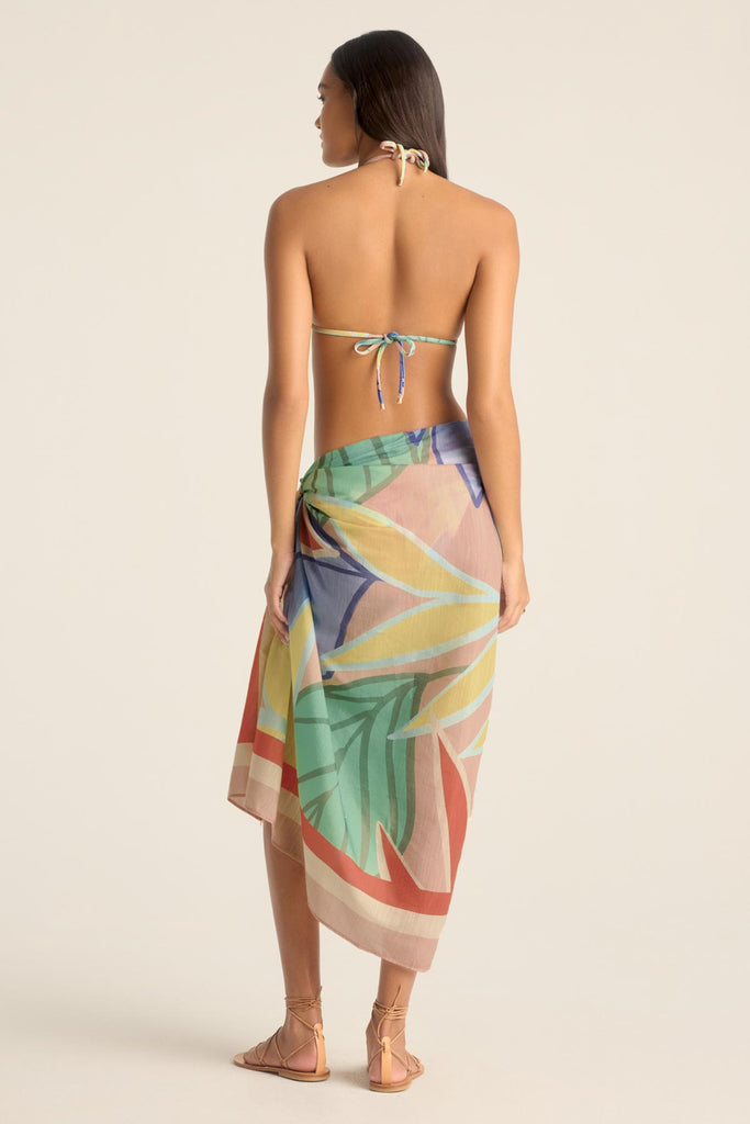 Woman turned away wearing a jungle printed bikini top with a matching swim cover up