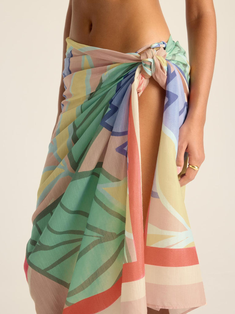 Woman wearing a jungle printed  swim cover up with side detail