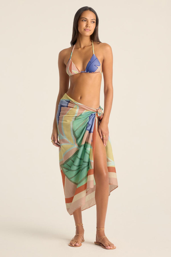 Woman wearing a jungle printed bikini top with a matching swim cover up