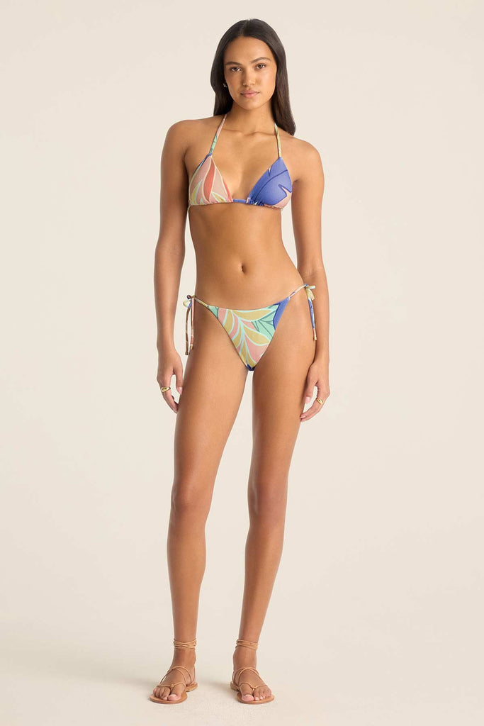Woman wearing a string bikini top with a jungle print and matching swim bottoms
