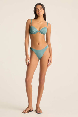 Woman wearing a metallic aqua swim top with matching swim bottoms