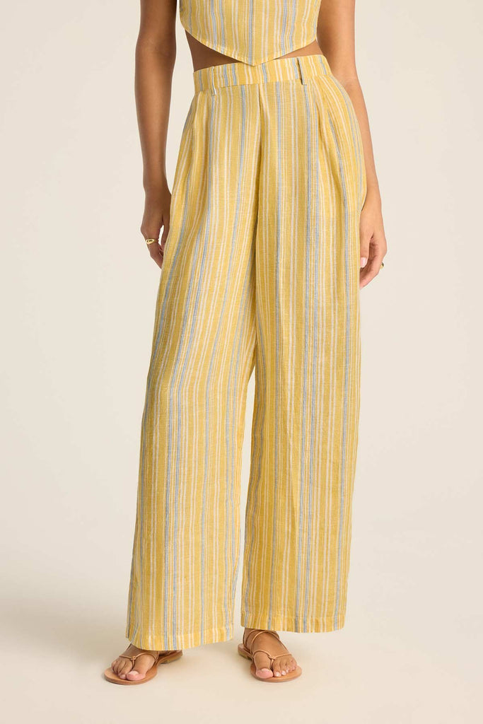Woman wearing a yellow and blue striped scarf beach top and close up of the matching beach pants