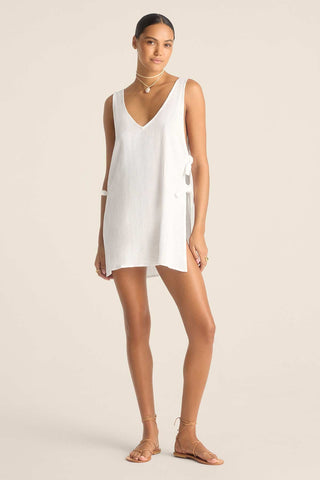 Woman wearing a white tank top style beach dress
