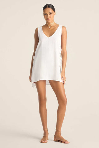 Woman wearing a white tank top style beach dress