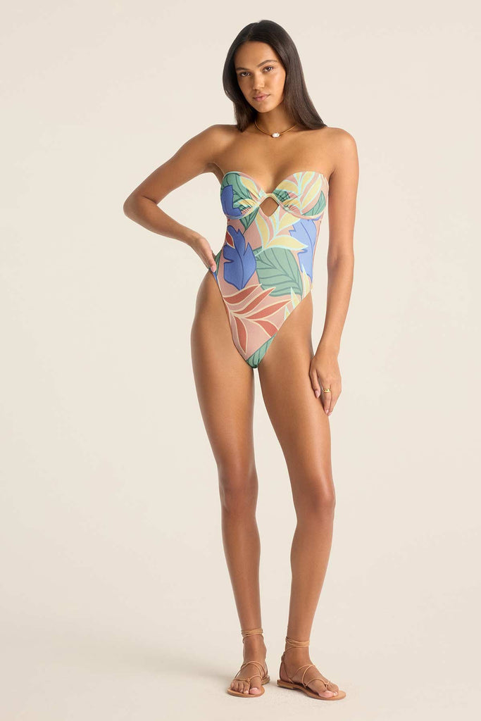 Woman wearing a bandeau one-piece jungle printed swimsuit